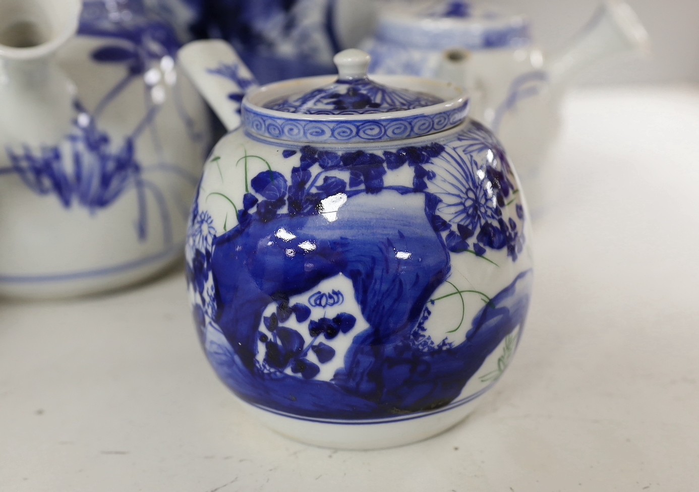 A pair of Japanese blue and white vases and various Japanese blue and white porcelain teapots and covers, tallest 30cm